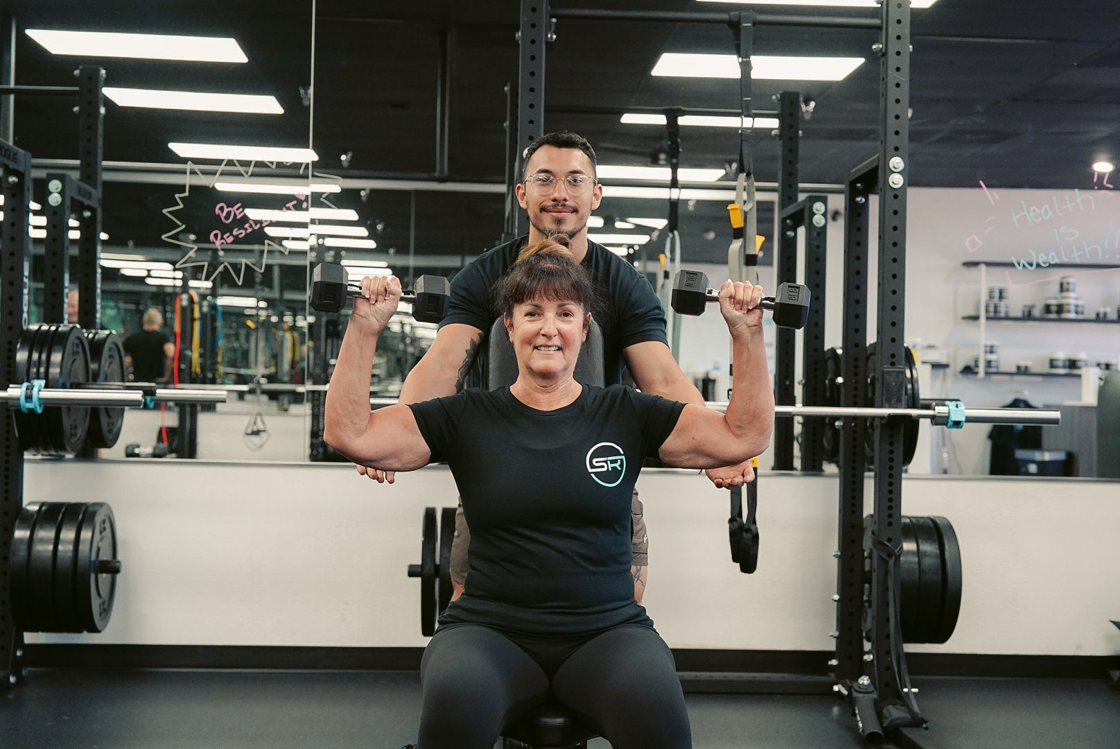 Personal trainer guiding exercise form in Palm Desert studio